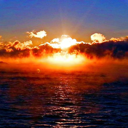 a sunset over a body of water